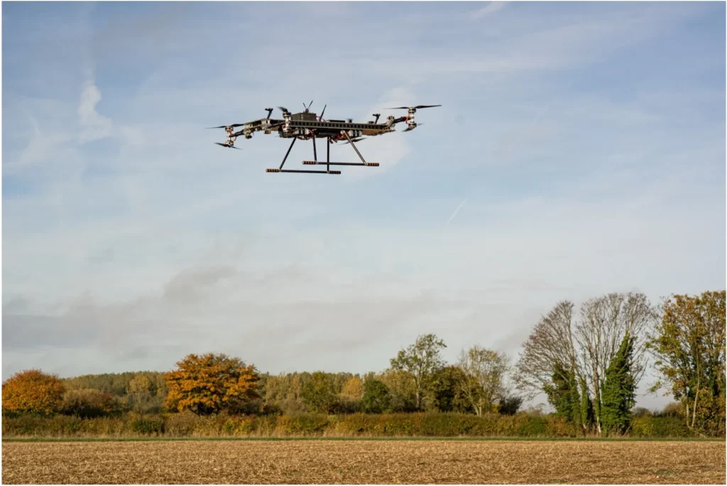 MGI R10 electric cargo eVTOL in flight over open field – modular drone platform for urban logistics and testing