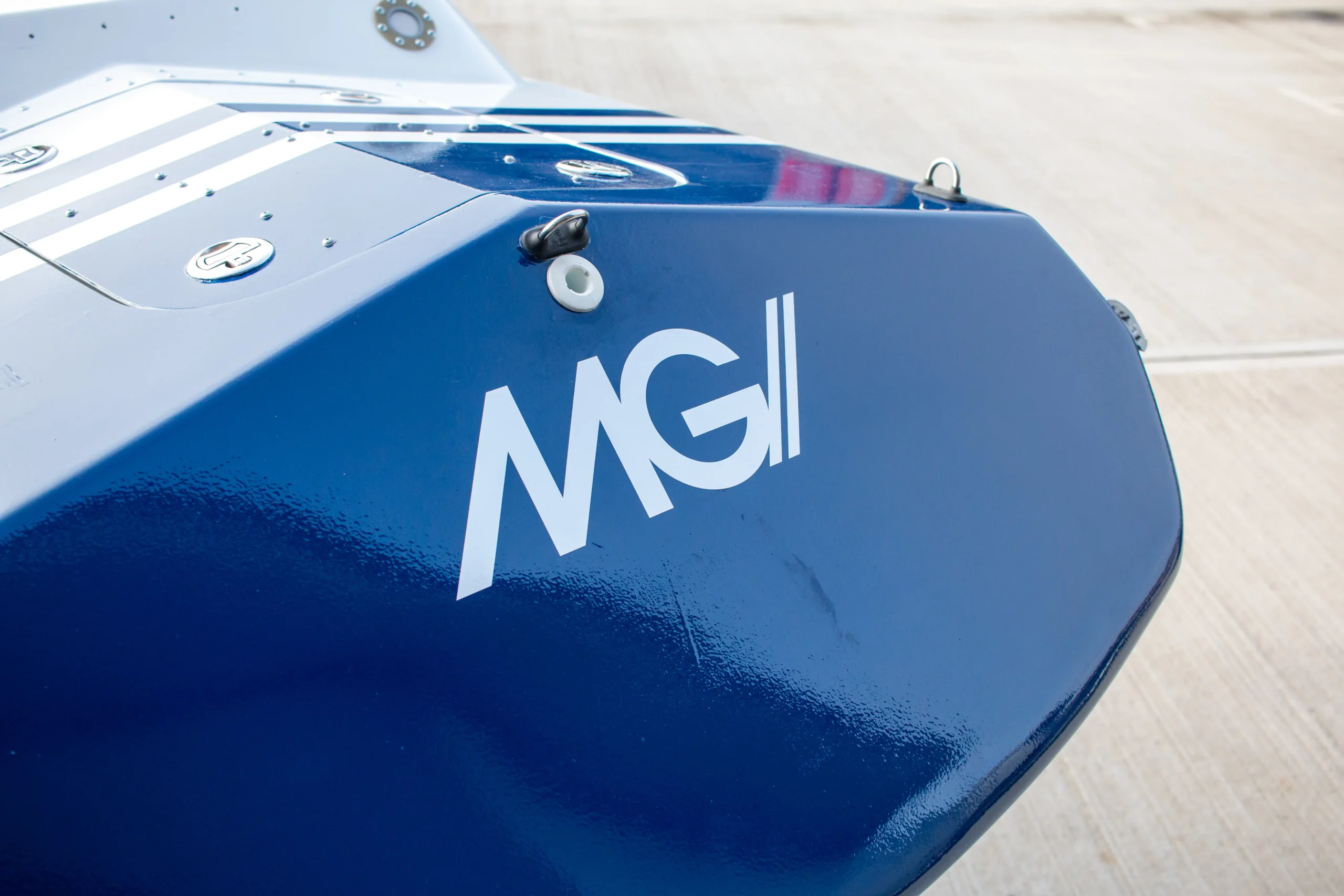 Close-up of MGI Seaglide’s blue hull featuring the MGI logo, designed for advanced autonomous underwater operations.