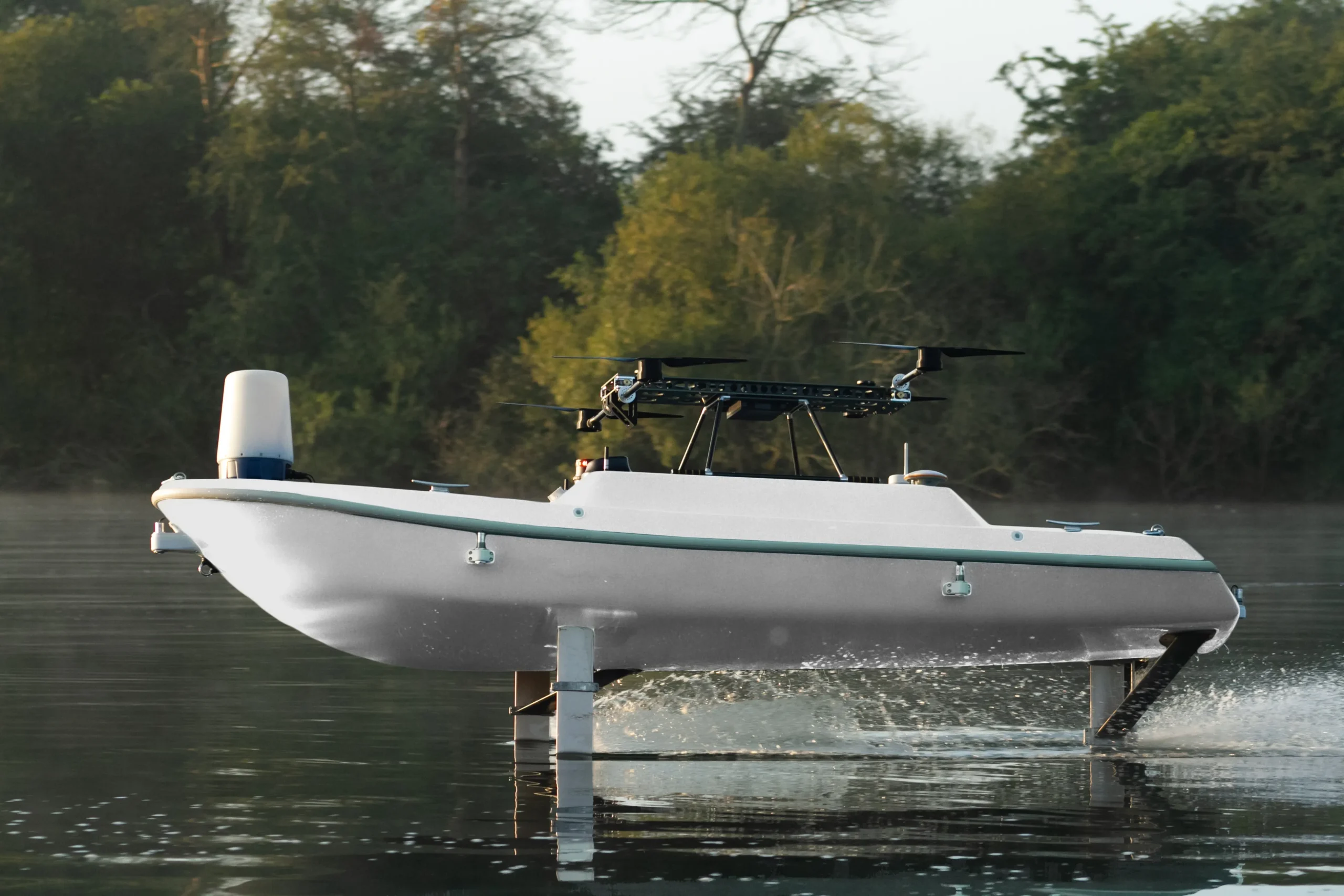 MGI SeaGlide autonomous surface vessel with R10 drone mounted for launch – maritime drone platform for multi-domain operations