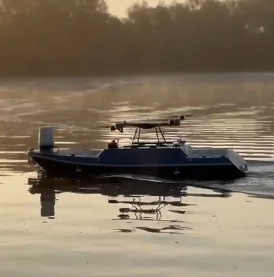 Autonomous SeaGlide surface drone conducting early morning ship-to-shore operations on calm water