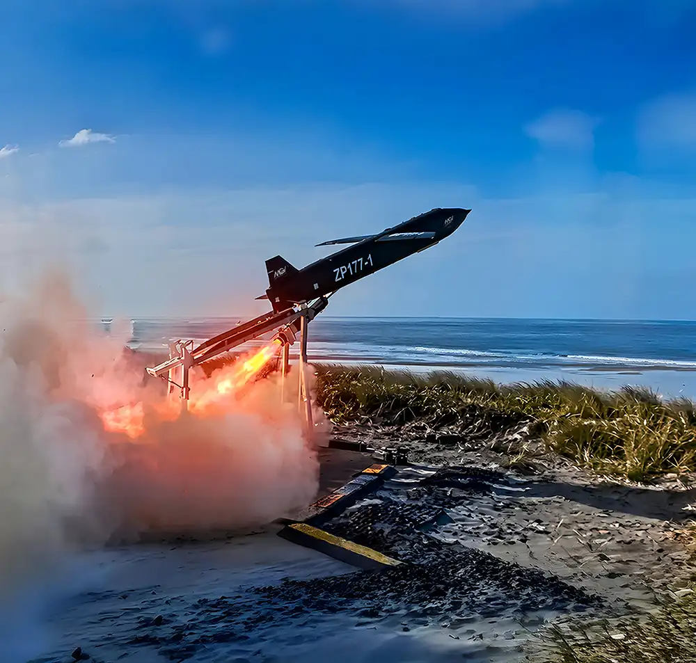 TigerShark one-way effector drone launching from coastal platform with rocket booster ignition